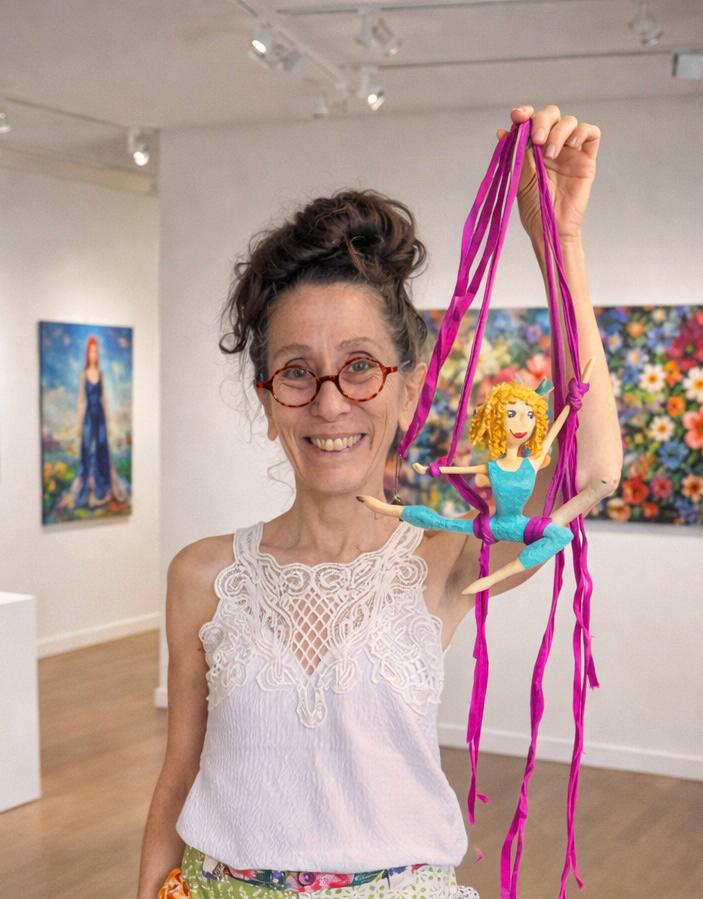 Dolores Montesó em seu ateliê segurando uma escultura em papel machê
